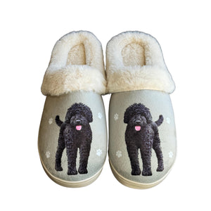 a pair of slippers with a black dog on them