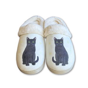 a pair of slippers with a black cat on them